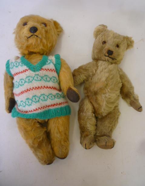A Chiltern musical teddy bear covered in gold plush with swivel joints Image