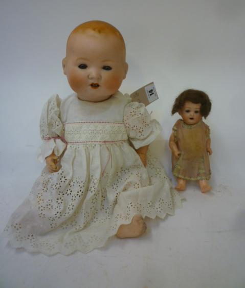 An Armand Marseille bisque head baby doll with blue glass sleeping eyes Image