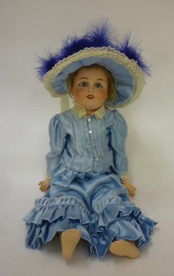 A Limoges bisque head doll with blue glass sleeping eyes Image