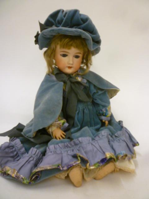 An Armand Marseille bisque head doll with blue glass sleeping eyes Image