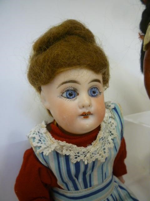 A French style bisque head doll with fixed blue glass eyes Image