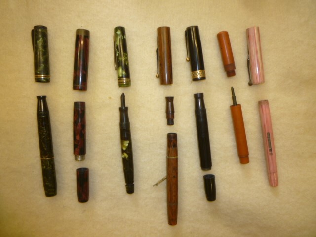 A "Swan Pens" wood easel display stand with seven fountain pen outers Image