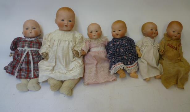 Four Armand Marseille bisque head baby dolls with blue glass sleeping eyes Image