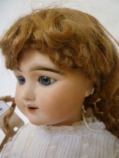 An S.F.B.J. "Eden Bebe" bisque head doll with fixed blue glass paperweight eyes Image