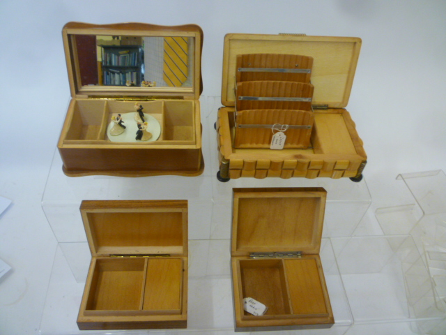Four musical cigarette boxes comprising carved satin birch box with silvered glass lid panel Image
