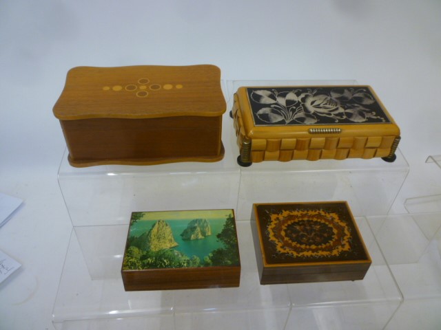 Four musical cigarette boxes comprising carved satin birch box with silvered glass lid panel Image