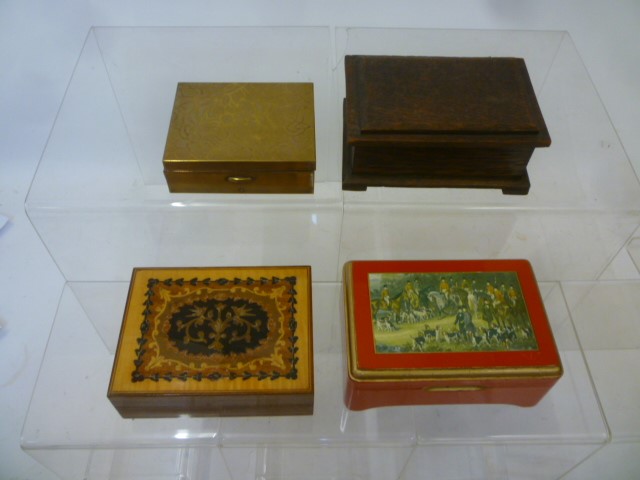 Four musical cigarette boxes comprising red lacquered box with hunting scene to lid Image