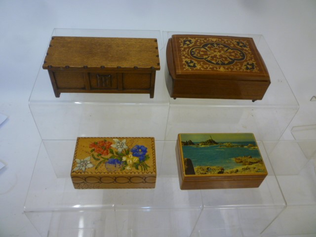 Three musical cigarette boxes comprising a string inlaid mahogany box with marquetry lid Image