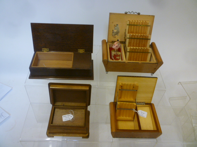 Four musical cigarette boxes comprising a beechwood scroll ended box Image