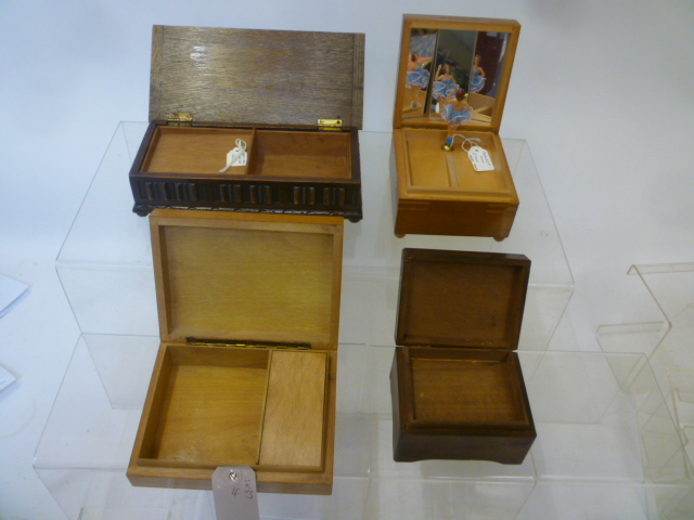 Four musical cigarette boxes comprising an oak carved box Image