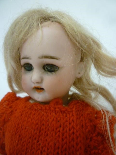 A Simon & Halbig bisque head doll with brown glass sleeping eyes Image