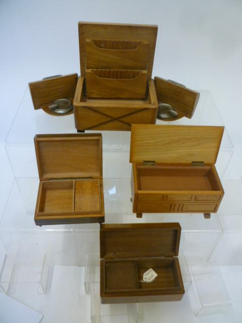 Four musical cigarette boxes comprising an inlaid beechwood box Image