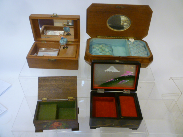 Four musical jewel boxes comprising a large fruitwood and marquetry inlaid box Image