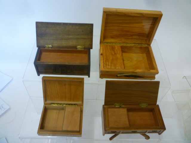 Four musical cigarette boxes comprising an olivewood box Image
