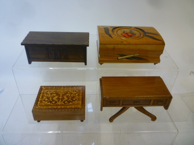 Four musical cigarette boxes comprising an olivewood box Image
