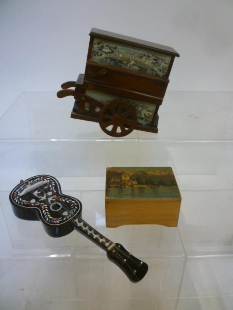 Three musical items comprising a barrel organ in stained wood case with printed panels Image