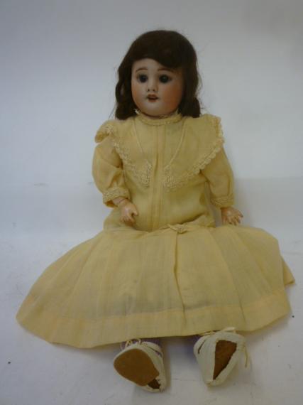 An S.F.B.J. bisque head doll with brown glass sleeping eyes Image