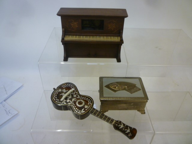 Three musical items comprising a pianola in stained wood case with Swiss two tune movement playing Image