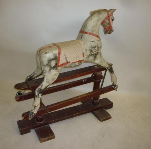 An AJOY Ltd small rocking horse on safety stand Image