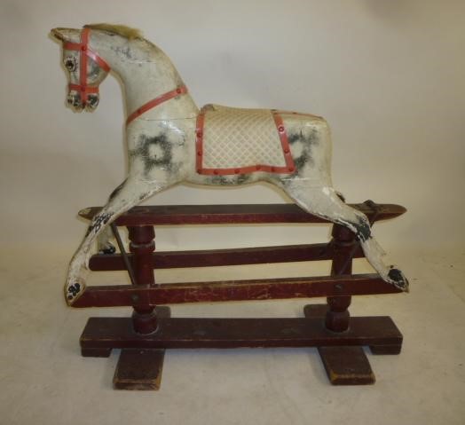 An AJOY Ltd small rocking horse on safety stand Image