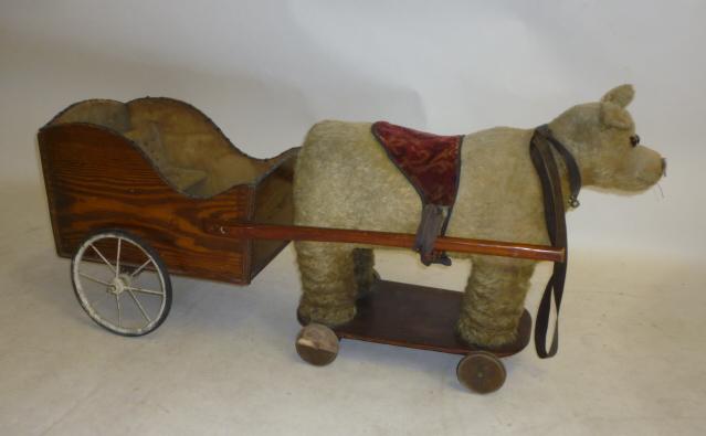 A pull-along "tubby teddy bear" with associated doll's cart Image