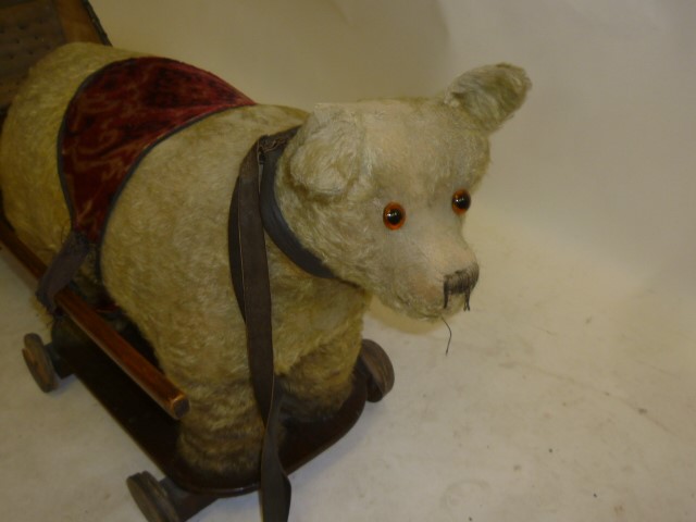 A pull-along "tubby teddy bear" with associated doll's cart Image
