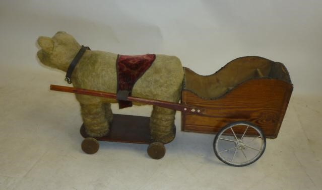 A pull-along "tubby teddy bear" with associated doll's cart Image