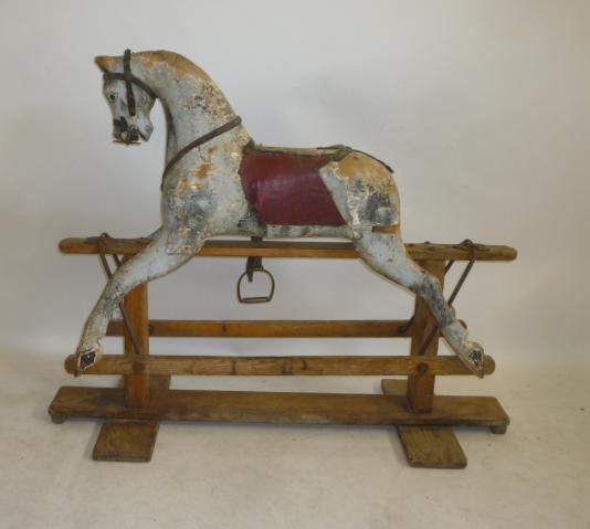 A rocking horse on safety stand by Baby Carriages Ltd Image