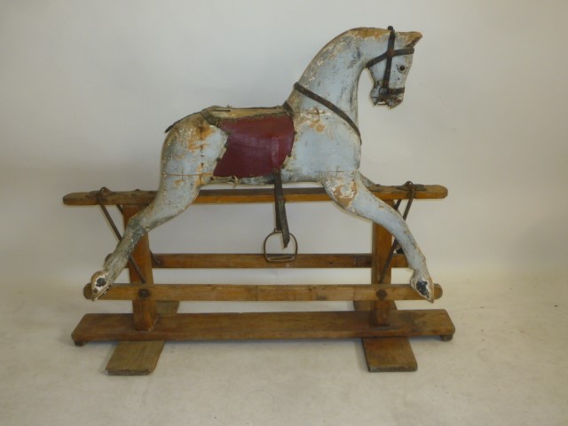 A rocking horse on safety stand by Baby Carriages Ltd Image