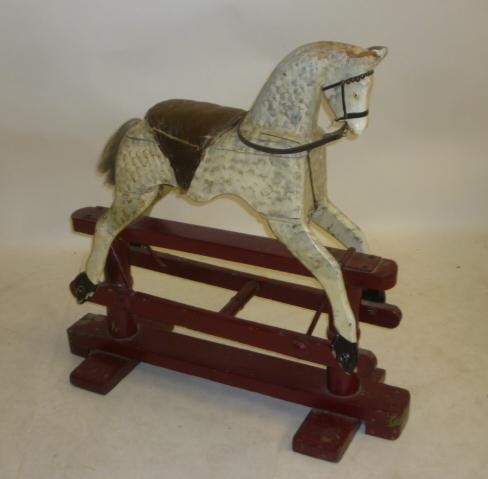 A small rocking horse on safety stand Image