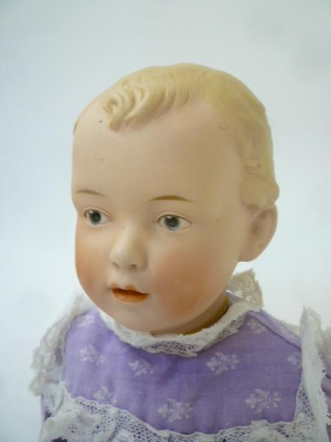 A Gebruder Heubach bisque head doll with painted face Image