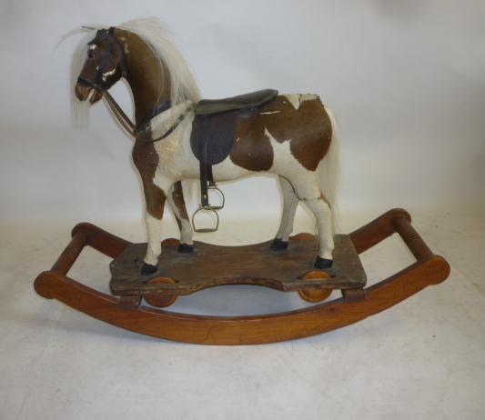 A small rocking horse on convertible stand Image
