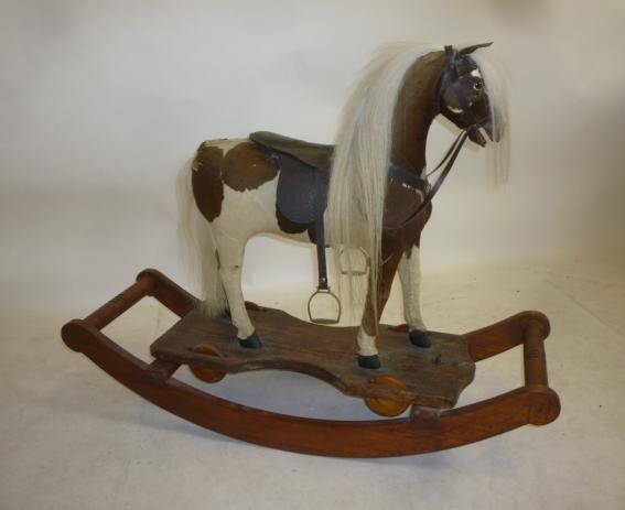 A small rocking horse on convertible stand Image