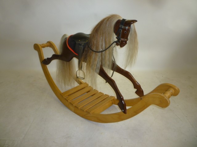 A small rocking horse by Anthony Dew in carved Brazilian mahogany with black/clear glass eyes Image