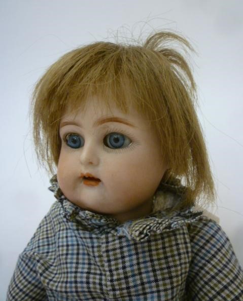 A Kammer & Reinhardt bisque head doll with blue glass sleeping eyes Image