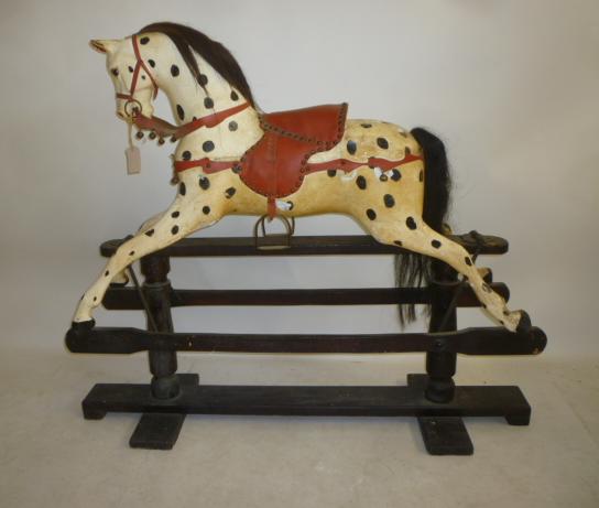 A medium rocking horse on safety stand Image