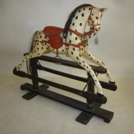 A medium rocking horse on safety stand Image