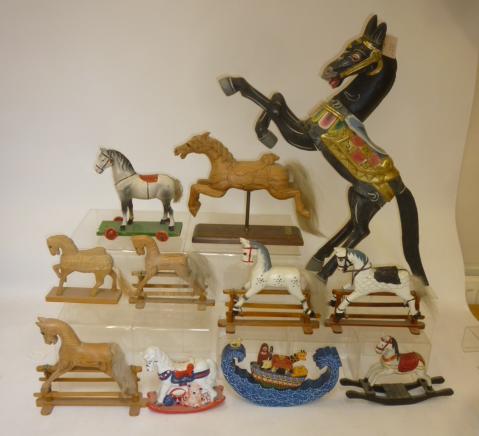 A collection of miniature rocking horses and horse figures comprising four painted and/or carved Image