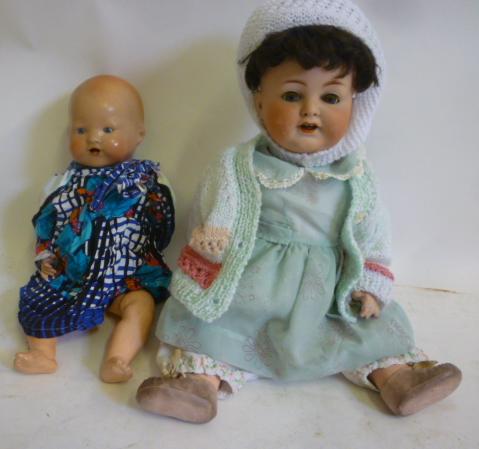 An Armand Marseille bisque head character doll with blue glass sleeping eyes Image