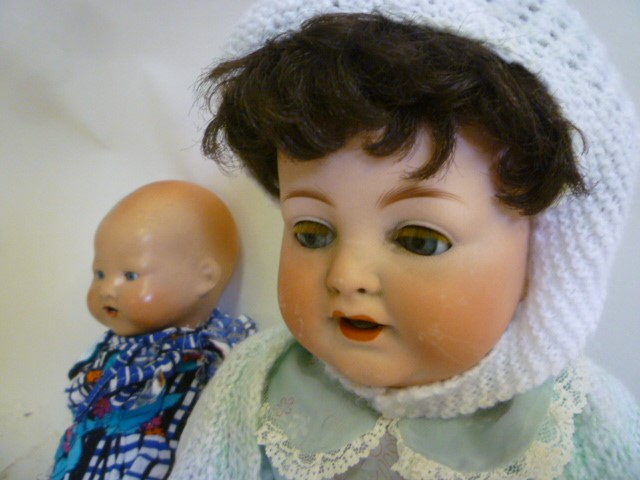 An Armand Marseille bisque head character doll with blue glass sleeping eyes Image