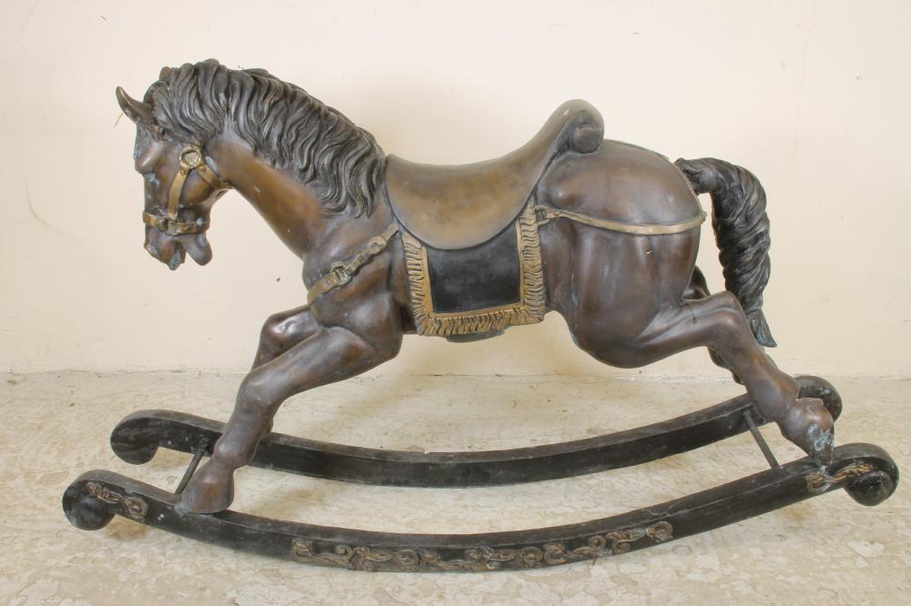 A cast bronze rocking horse garden ornament with integral saddle and harness and bow rockers with Image