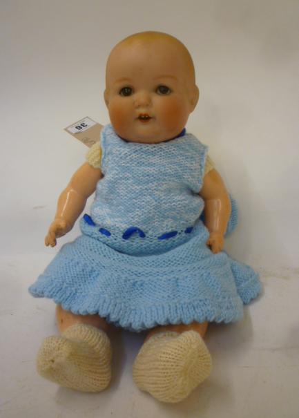 An Armand Marseille bisque head baby doll with brown glass sleeping eyes Image