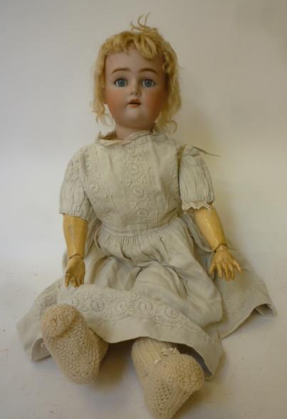 A Kammer & Reinhardt bisque head doll with blue glass sleeping eyes Image