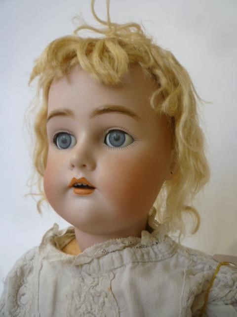 A Kammer & Reinhardt bisque head doll with blue glass sleeping eyes Image