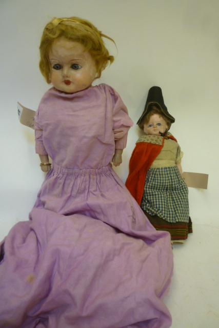 Two composition dolls comprising early 20th century doll with inset blue glass eyes Image