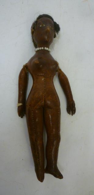 An early 19th century stitched leather doll with inset painted eyes Image