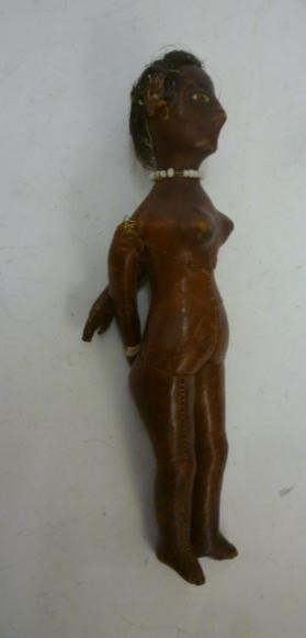 An early 19th century stitched leather doll with inset painted eyes Image