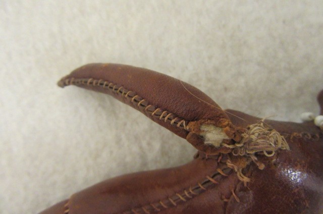 An early 19th century stitched leather doll with inset painted eyes Image