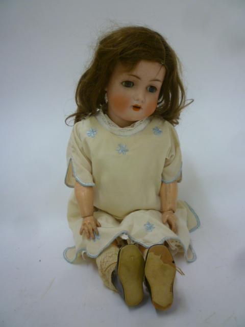 A Bruno Schmidt bisque head doll with blue glass sleeping eyes Image