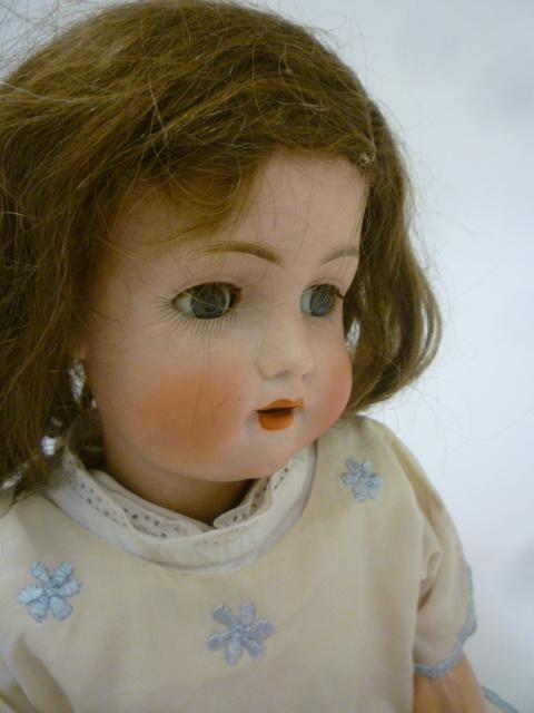 A Bruno Schmidt bisque head doll with blue glass sleeping eyes Image